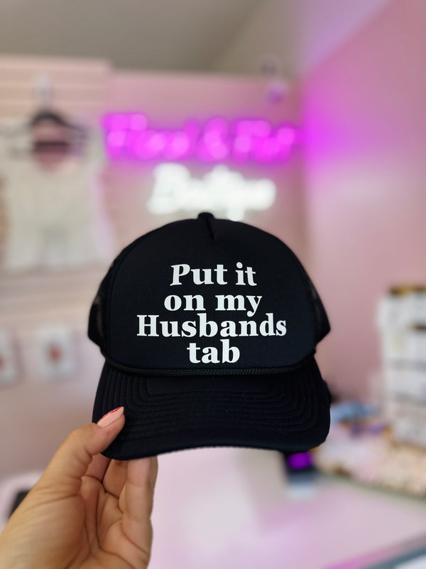 Put It On My Husbands Tab Trucker Hat